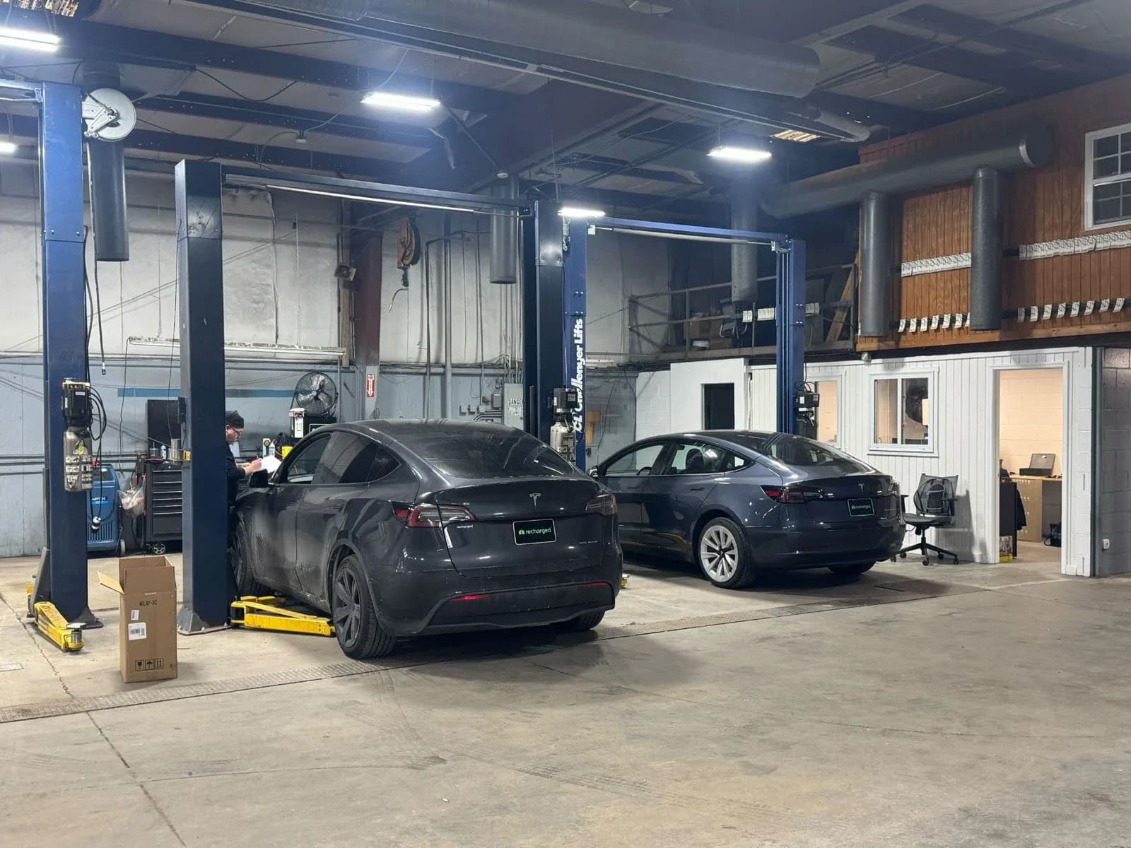 Electric vehicles being serviced in the Recharged reconditioning center
