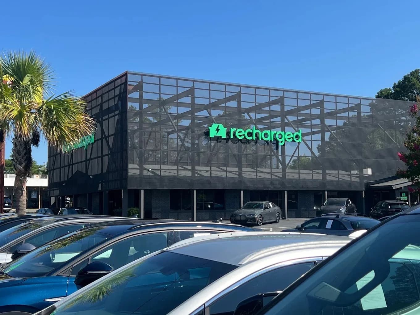 Recharged Experience Center exterior with EVs parked out front